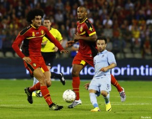 France's Valbuena is challenged by Belgium's Fellaini and Kompany during their international friendly soccer match at the King Baudouin stadium in Brussels